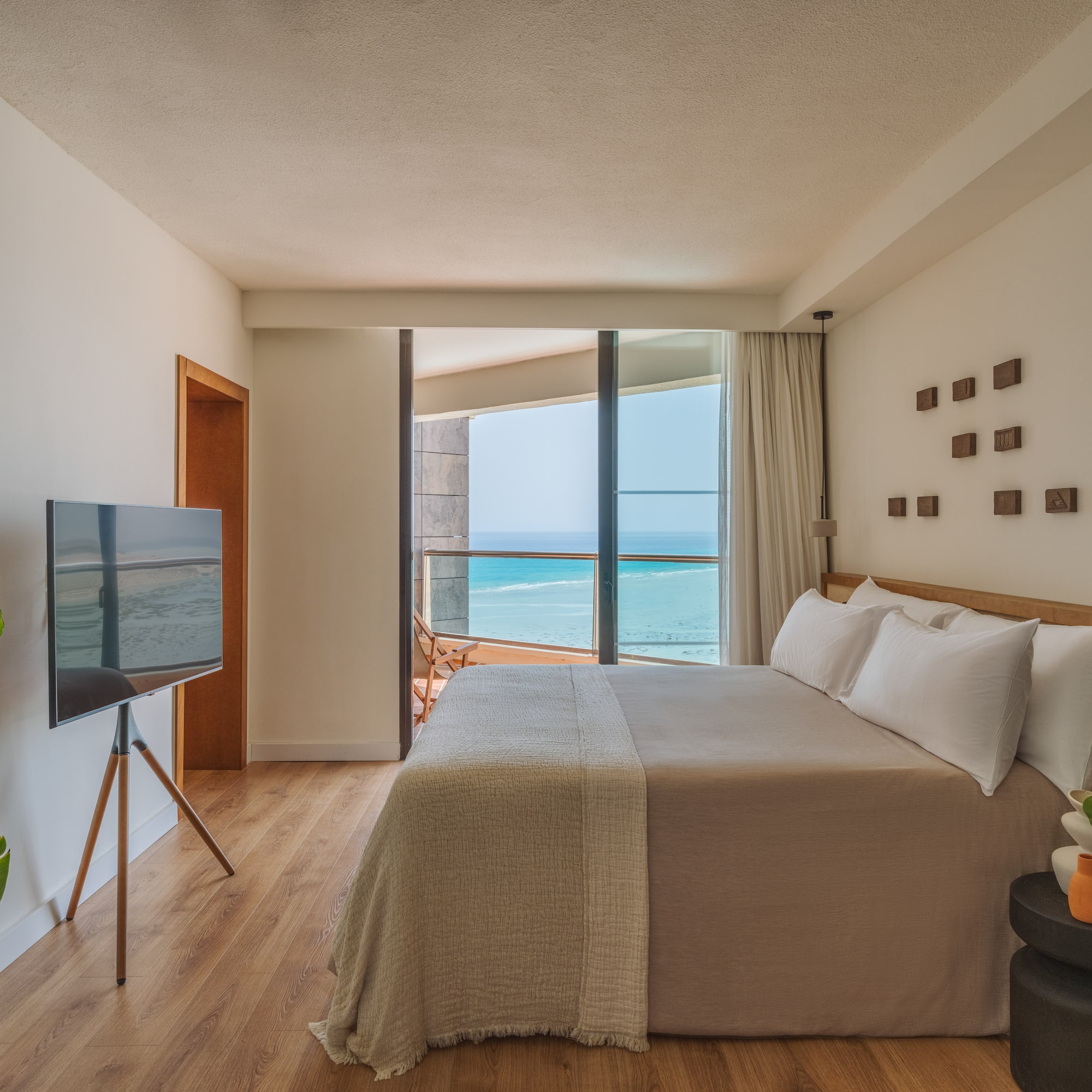 a bedroom with a television and a large window