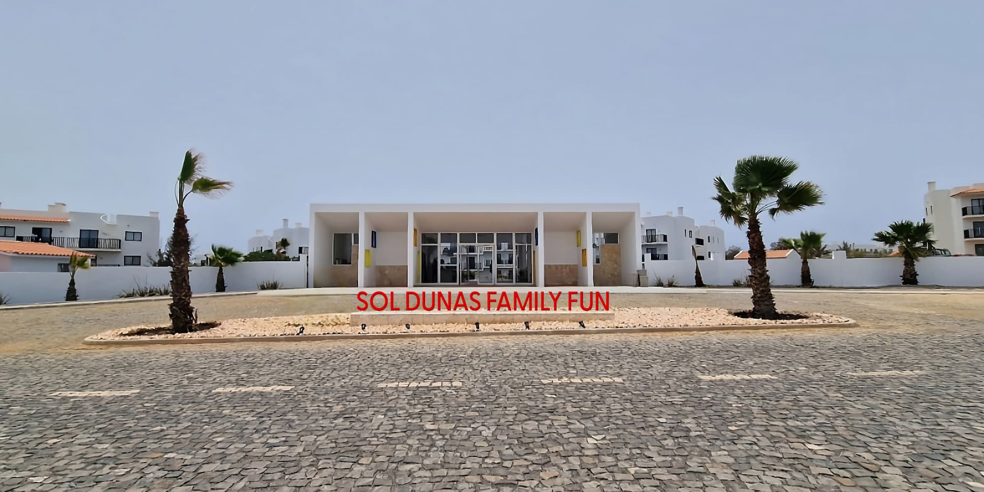 a building with palm trees in front of it