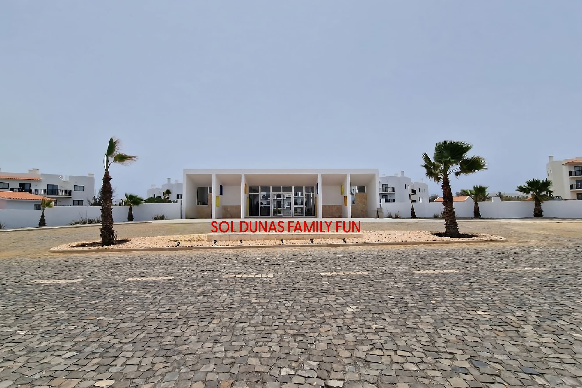 a building with palm trees in front of it