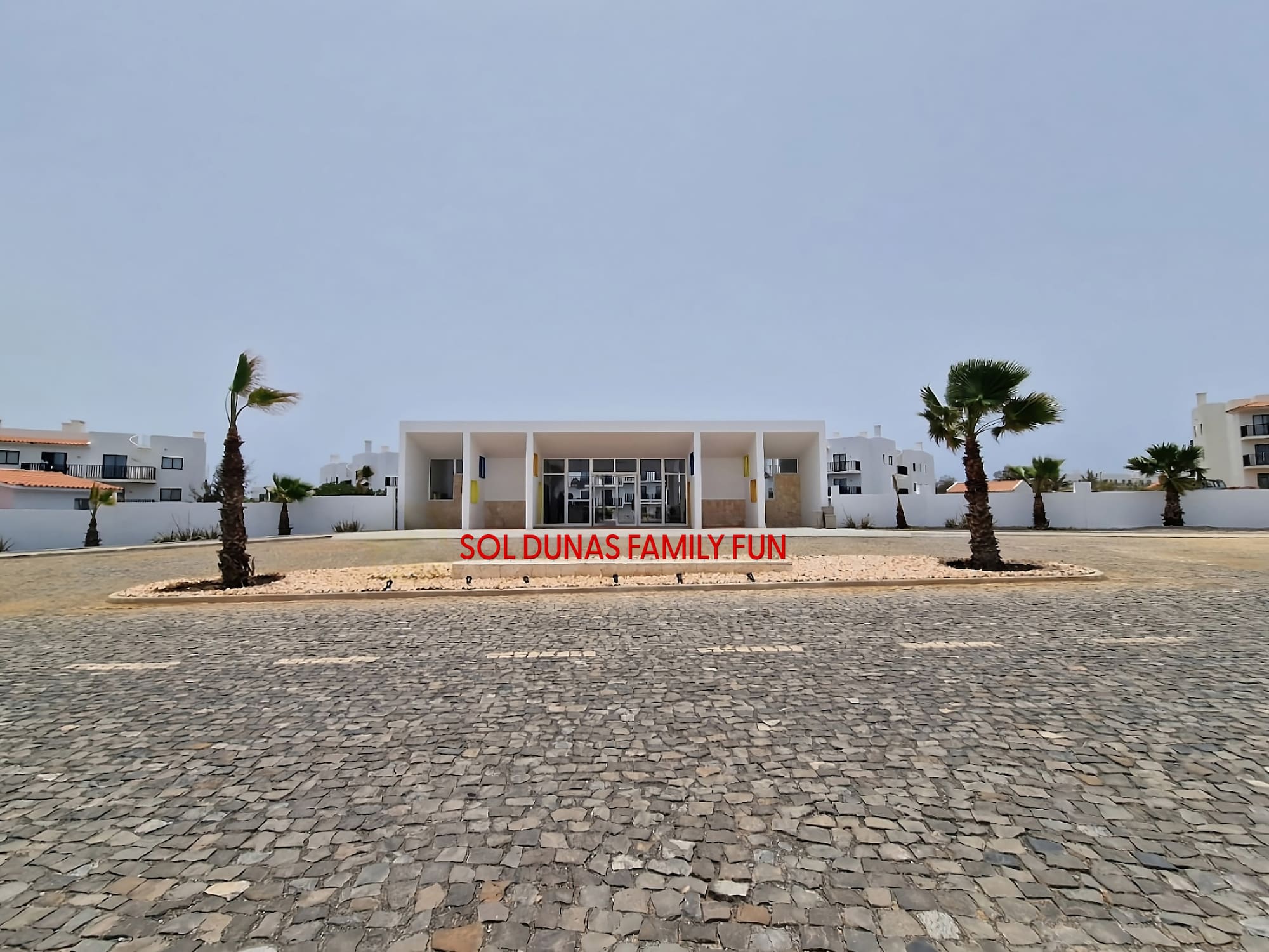 a building with palm trees in front of it
