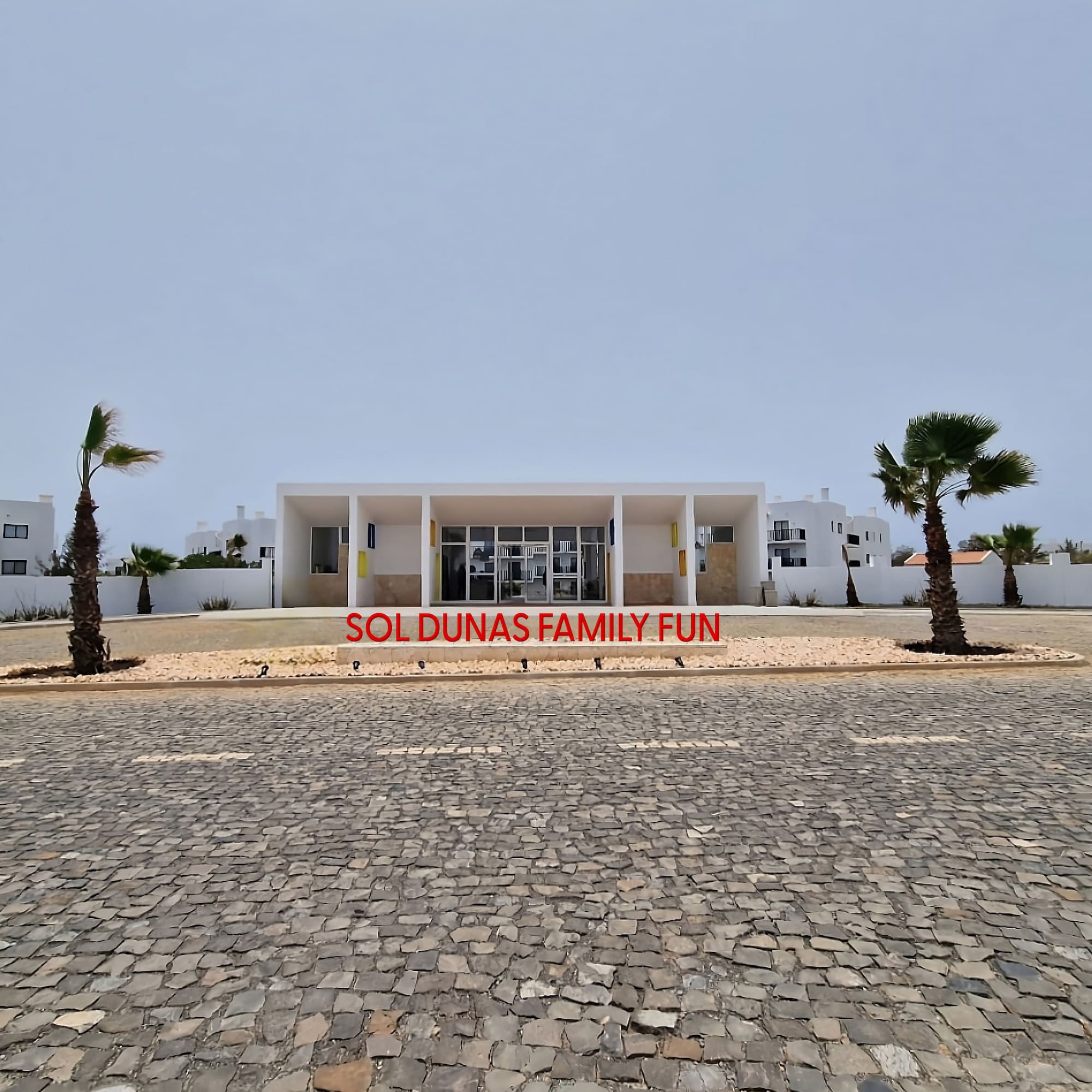 a building with palm trees in front of it