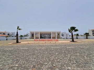 a building with palm trees in front of it