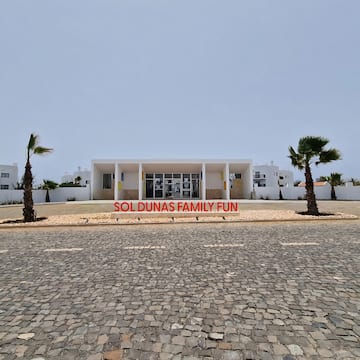 a building with palm trees in front of it