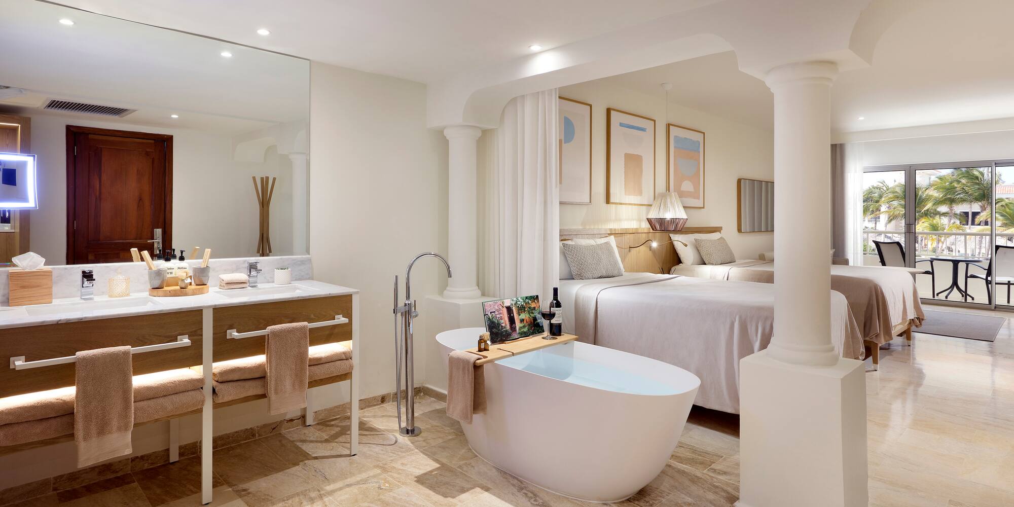 a bathroom with a tub and a double bed