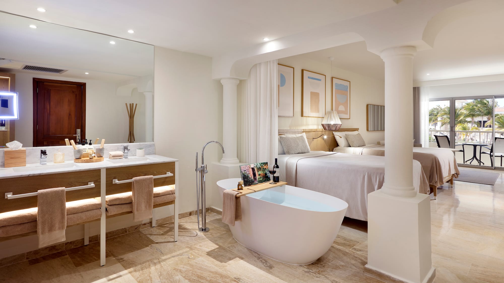 a bathroom with a tub and a double bed