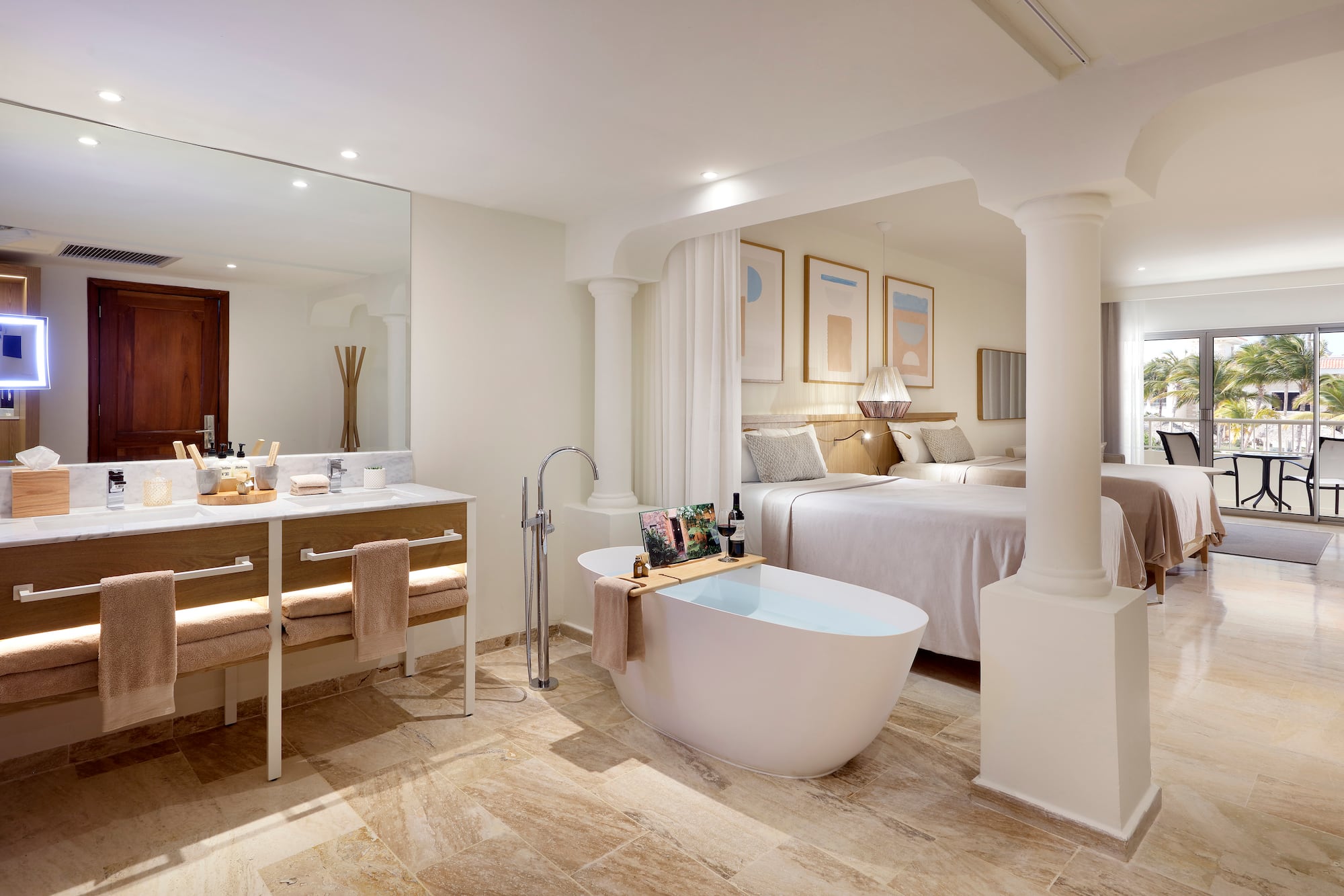 a bathroom with a tub and a double bed