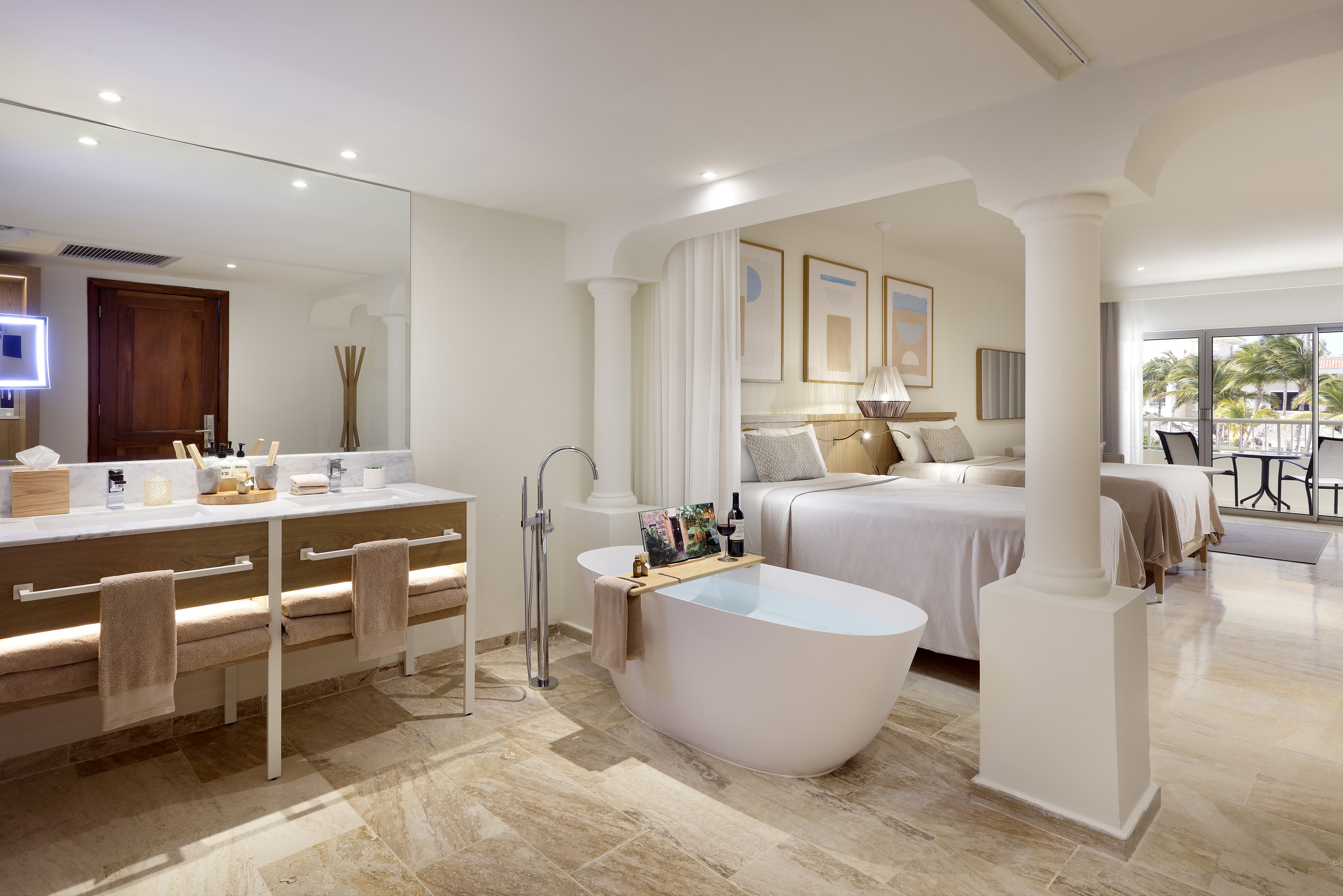 a bathroom with a tub and a double bed