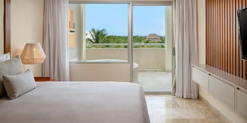 a bedroom with a glass door and a bed