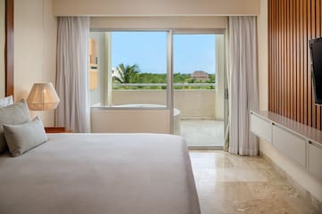 a bedroom with a glass door and a bed