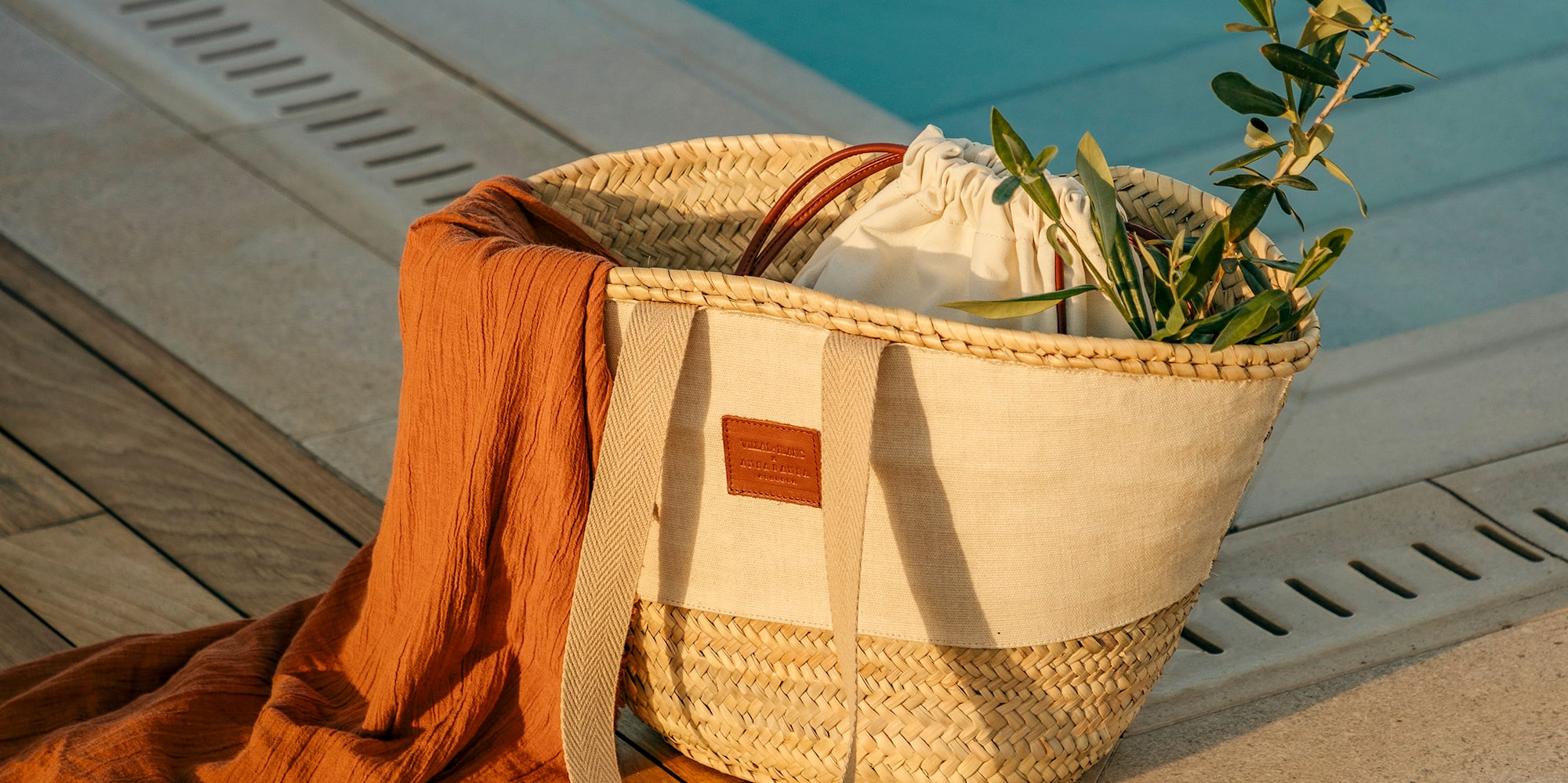 a bag and sandals next to a pool