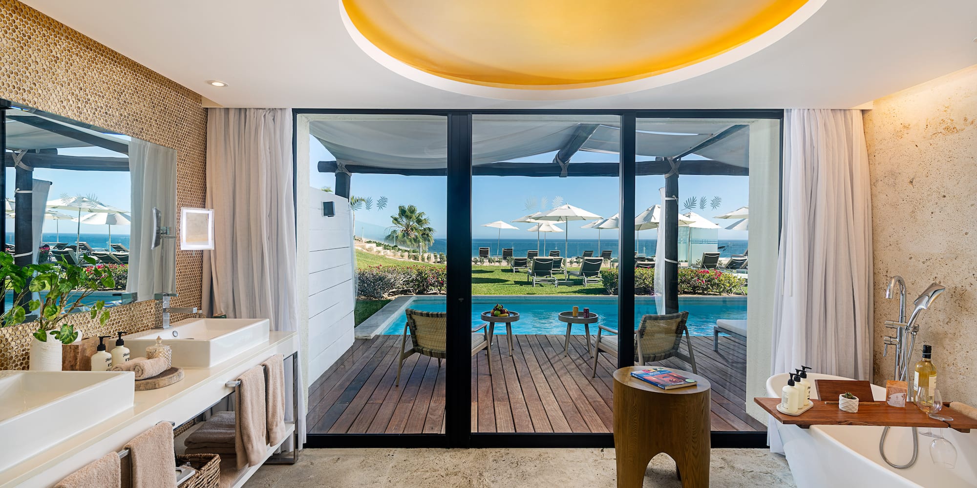 a bathroom with a pool and a deck
