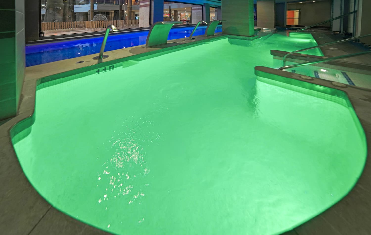 a pool with green lights