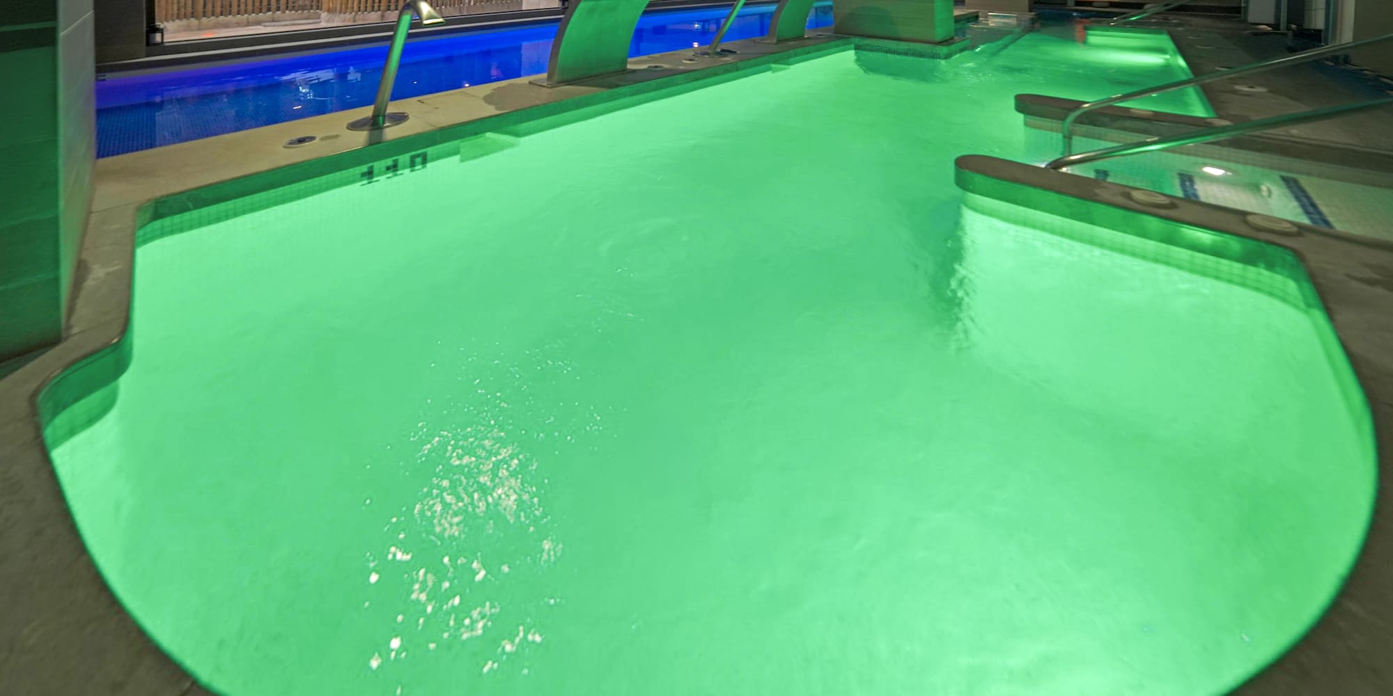 a pool with green lights