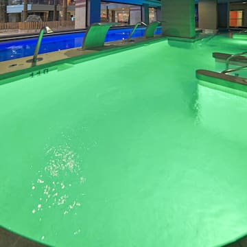 a pool with green lights