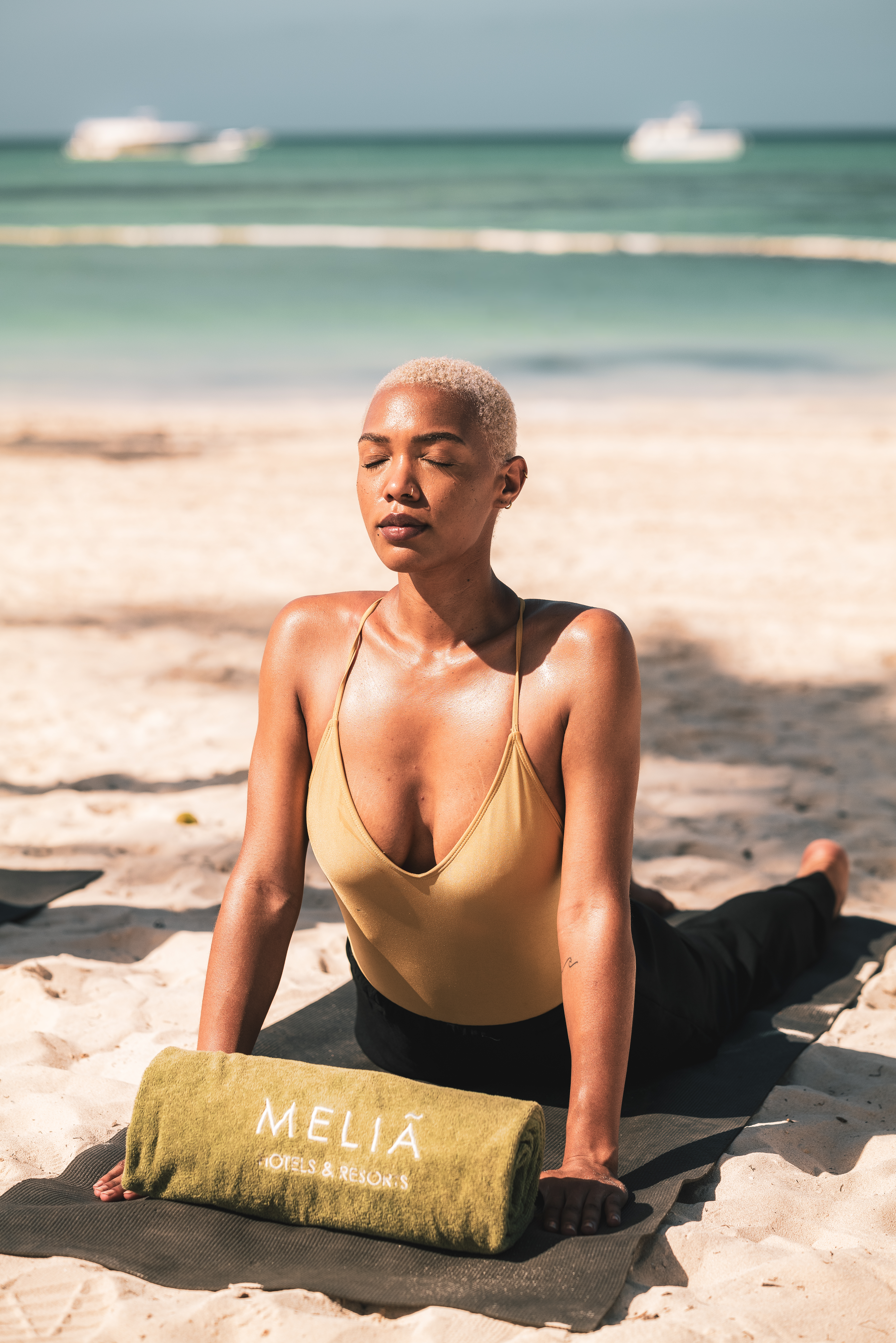 a woman doing yoga on the beach