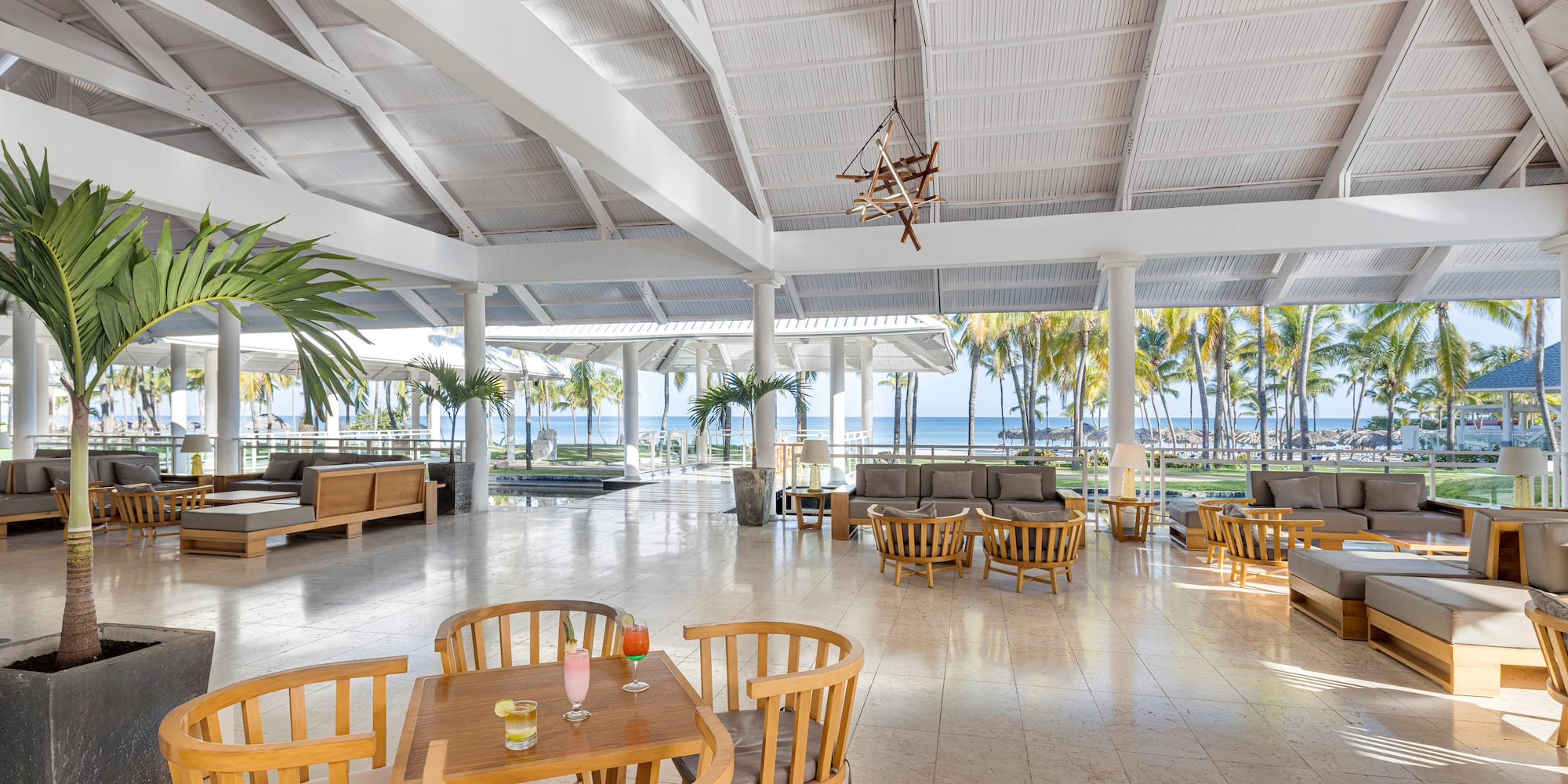 a room with tables and chairs and a large ceiling