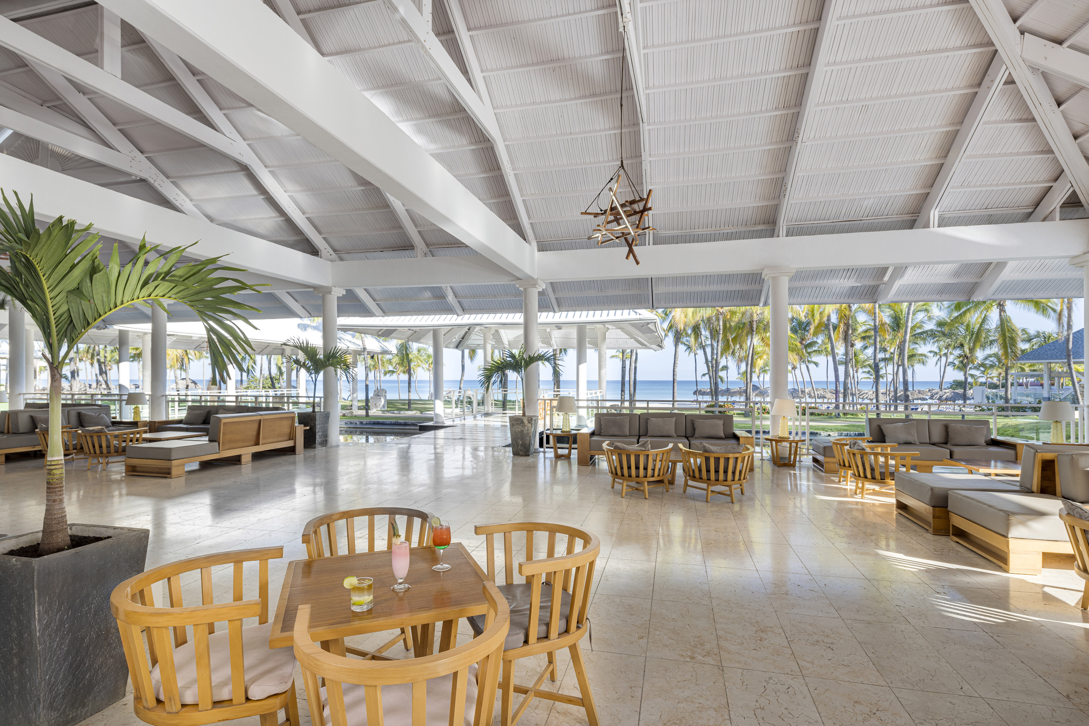 a room with tables and chairs and a large ceiling