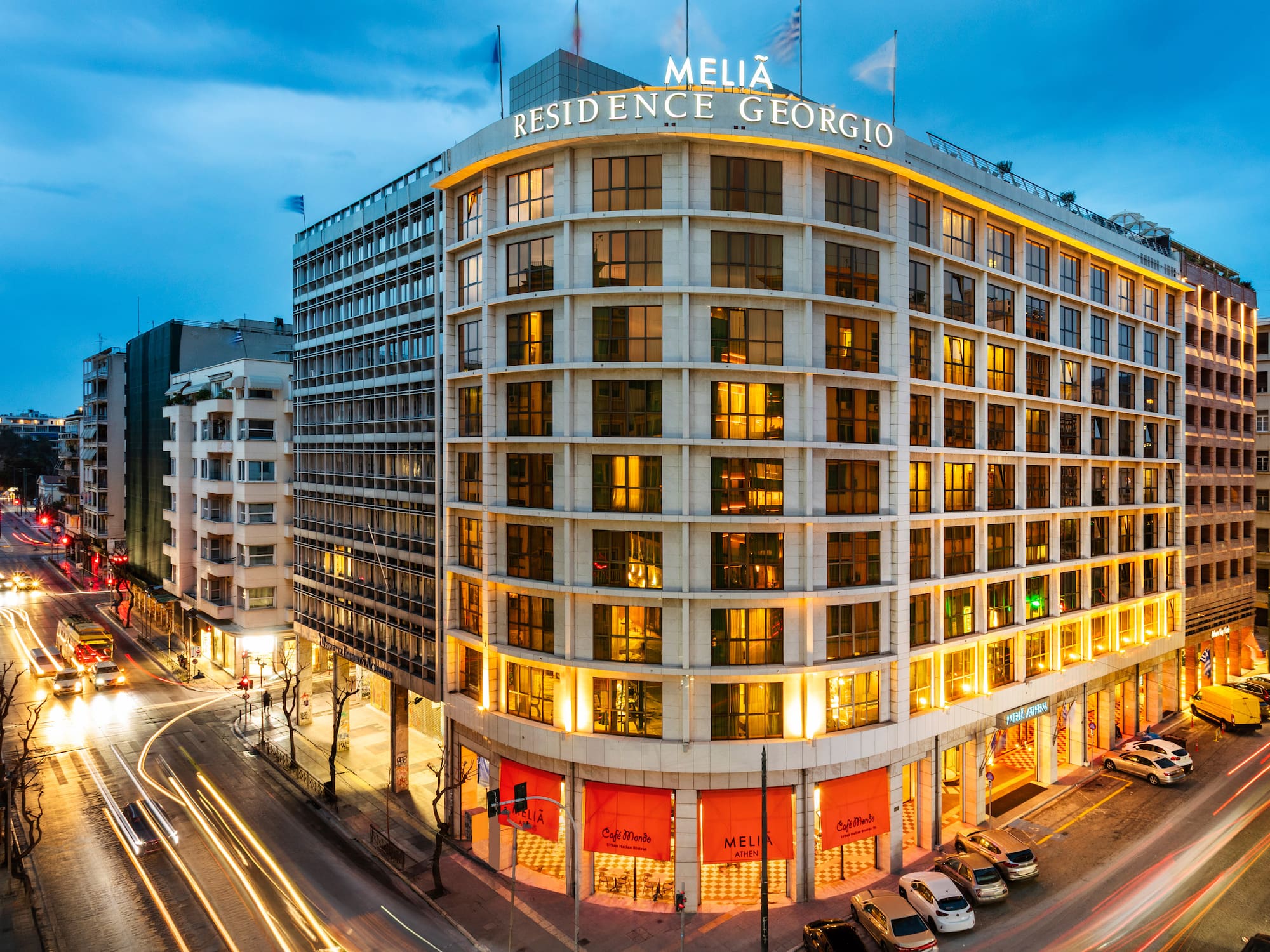 Melia Residence Georgio Athens, illuminated at night with street traffic light trails.