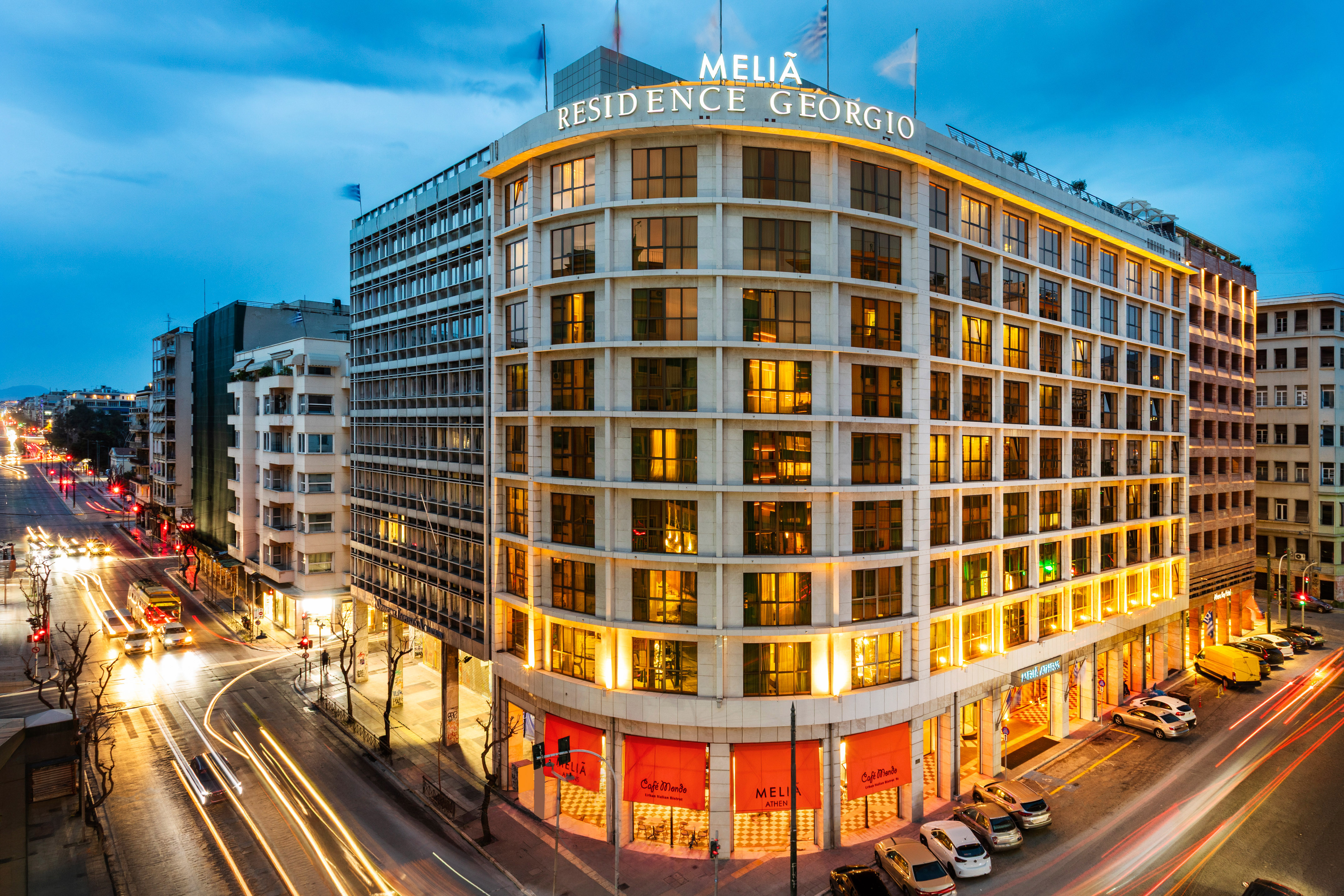 Meliá Residence Georgio hotel Athens, dusk, illuminated facade, street traffic trails.