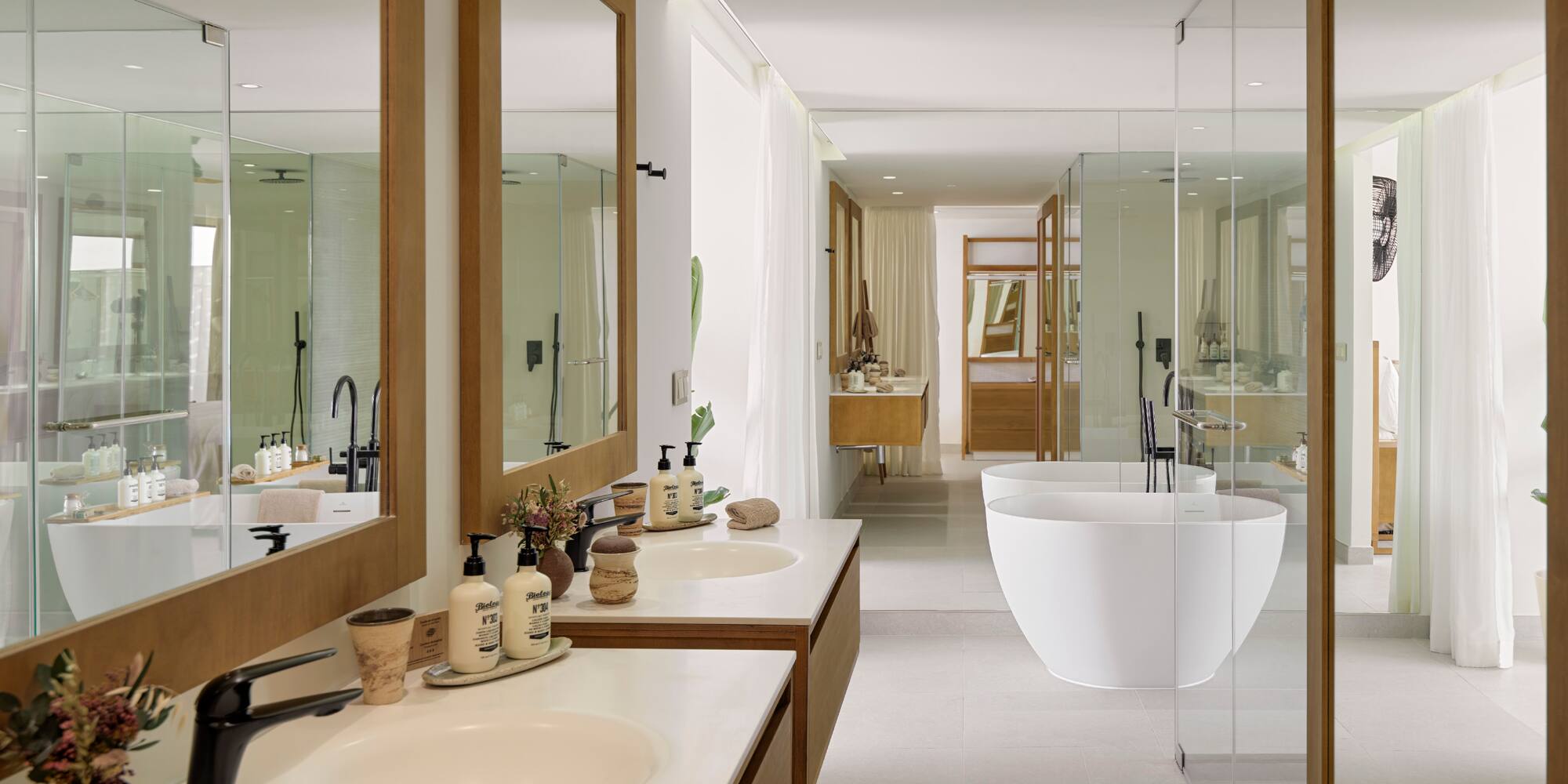 a bathroom with sinks and tub