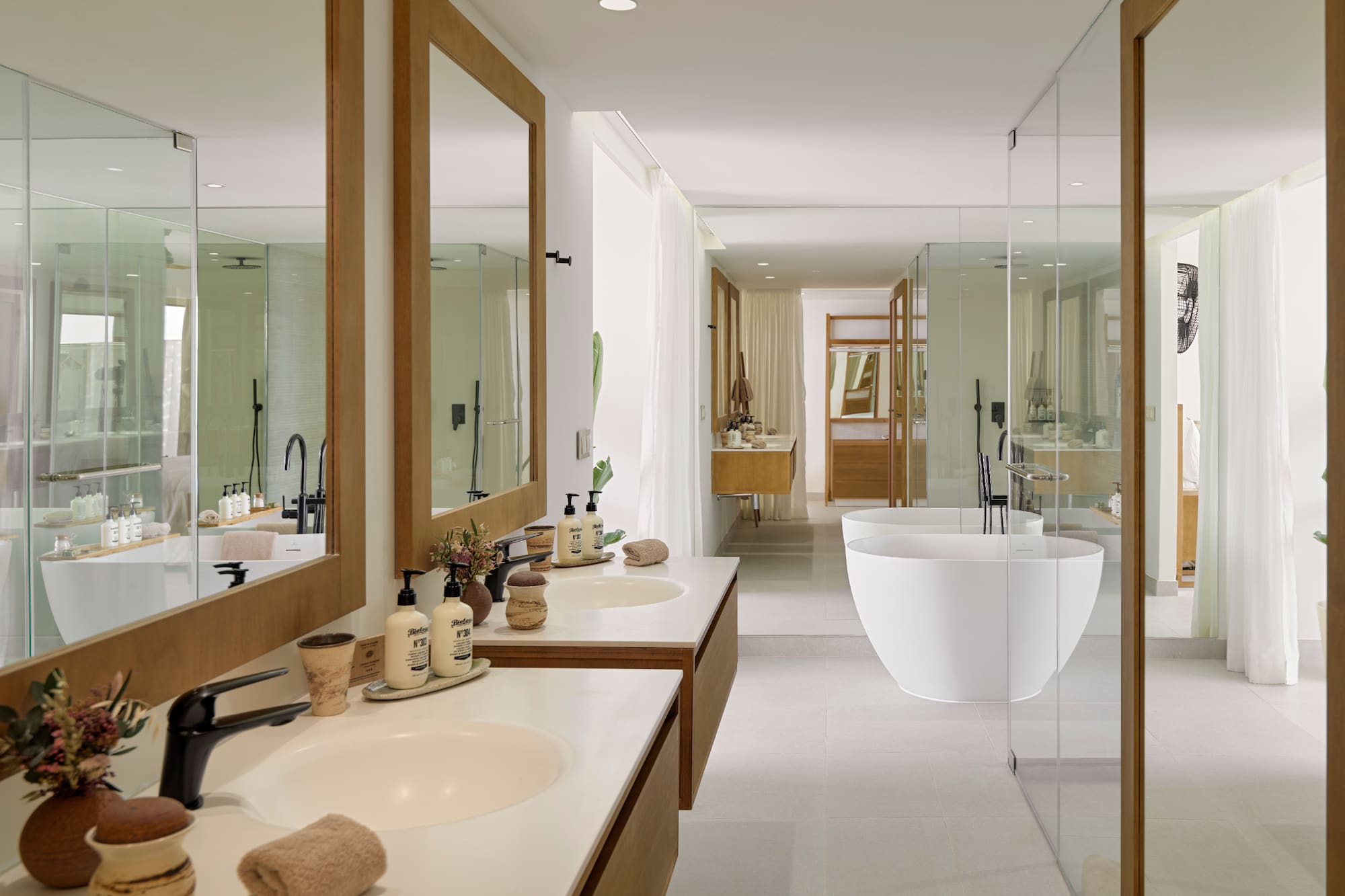 a bathroom with sinks and tub