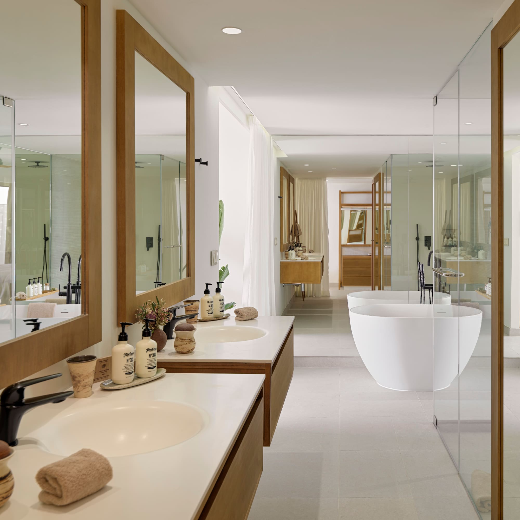a bathroom with sinks and tub