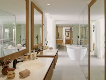 a bathroom with sinks and tub