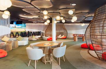 a room with a round table and chairs