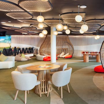 a room with a round table and chairs