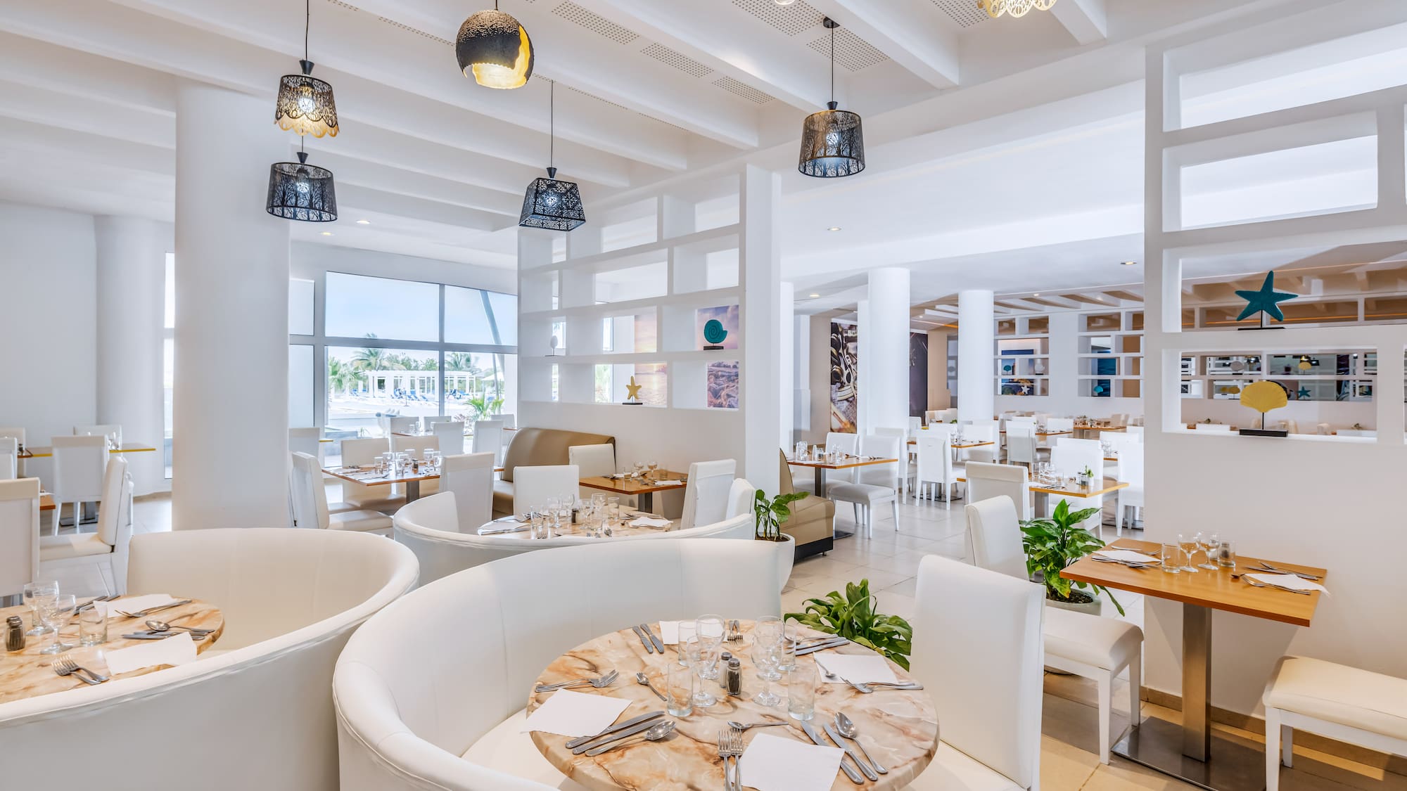 a room with white furniture and tables