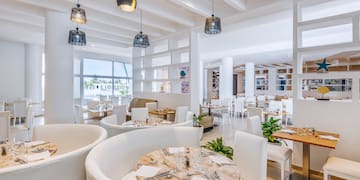 a room with white furniture and tables