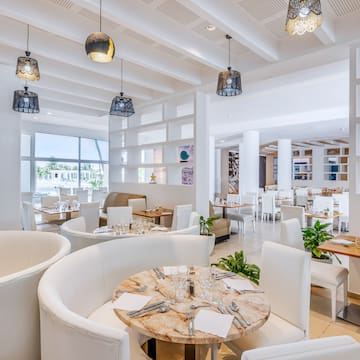 a room with white furniture and tables