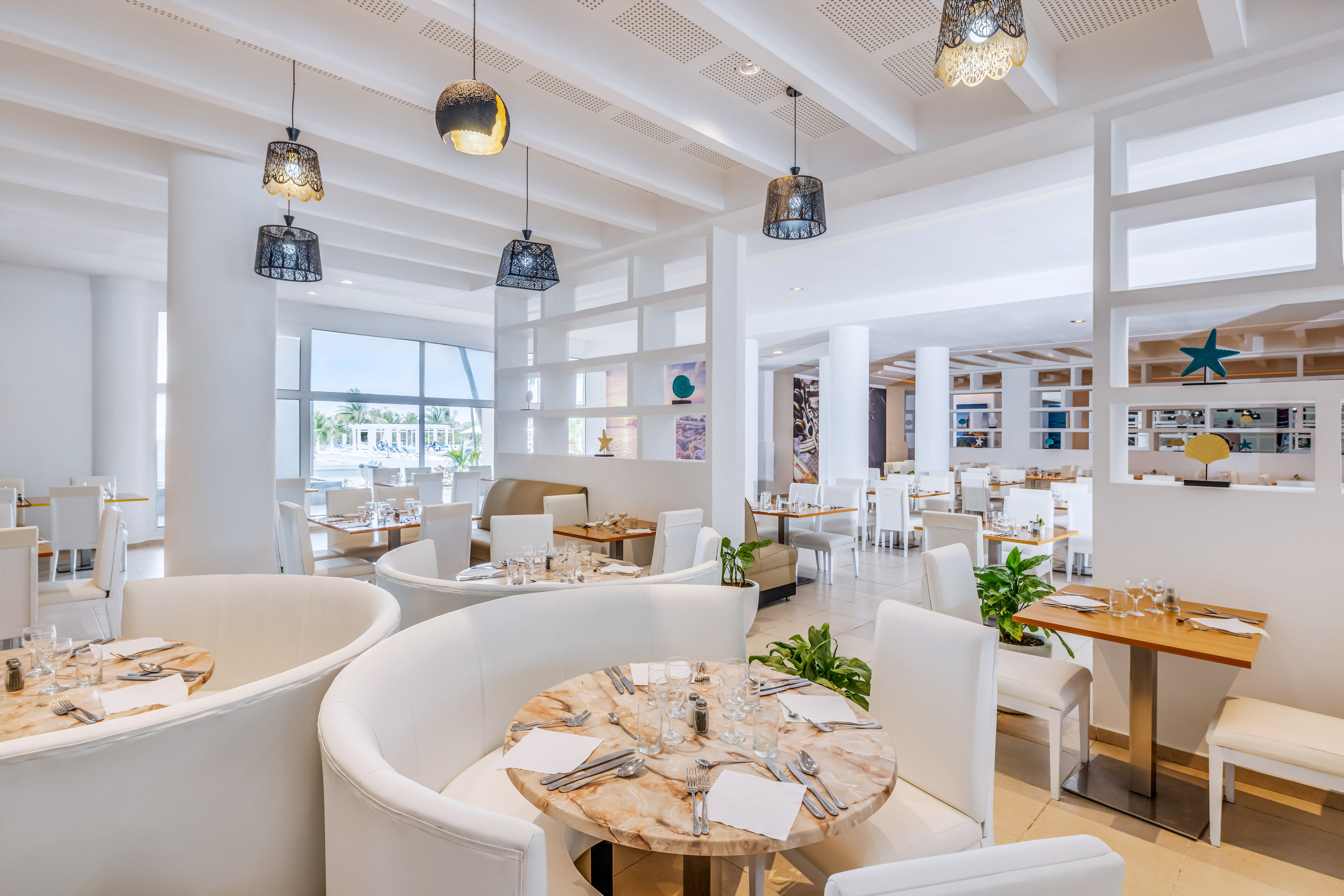 a room with white furniture and tables