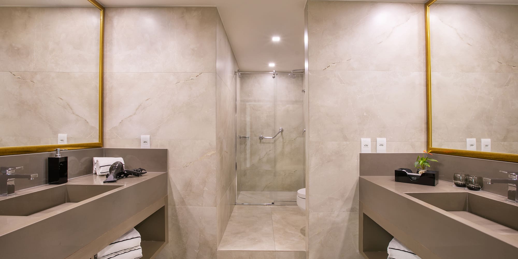 a bathroom with a shower and two sinks