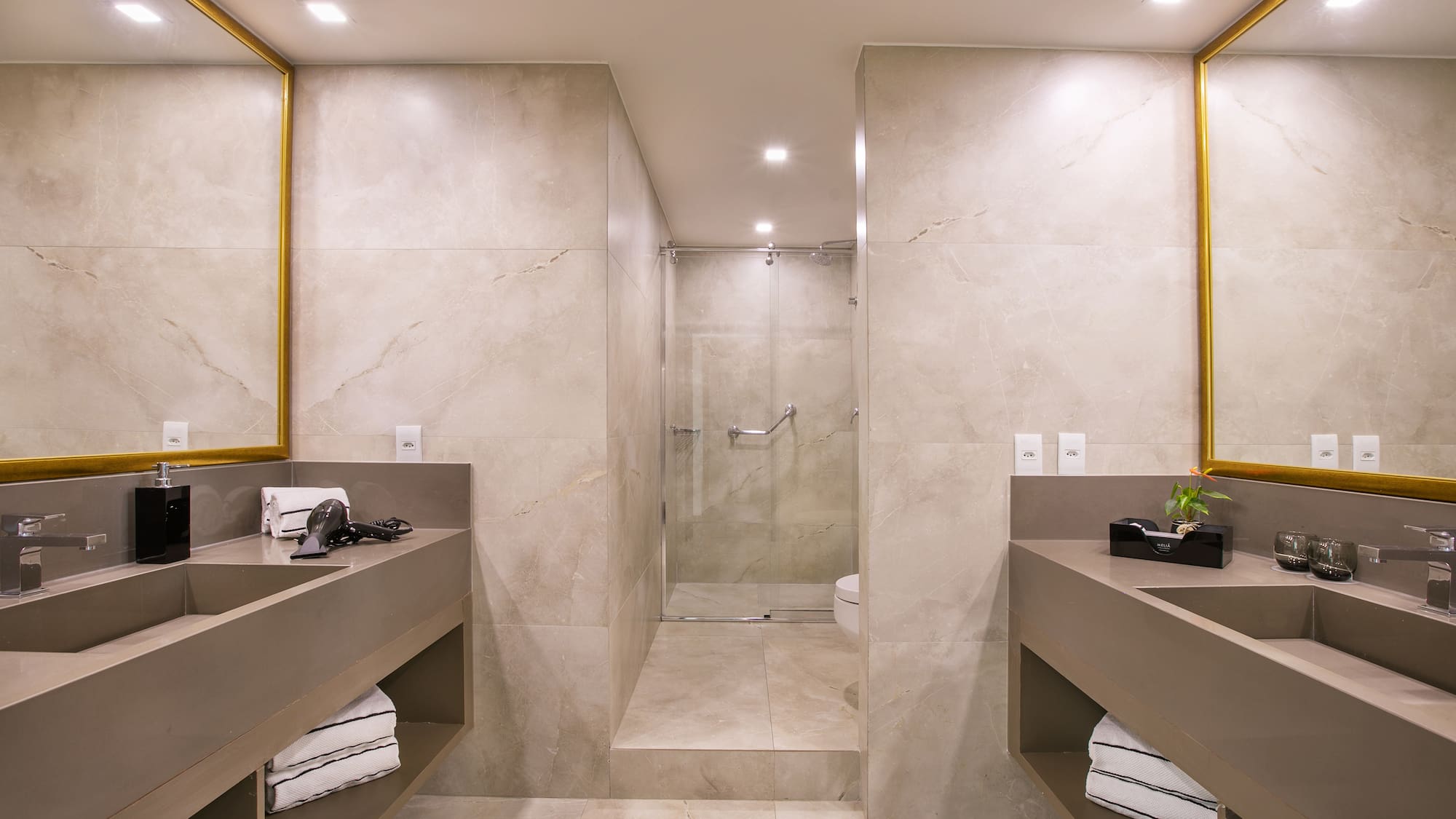 a bathroom with a shower and two sinks