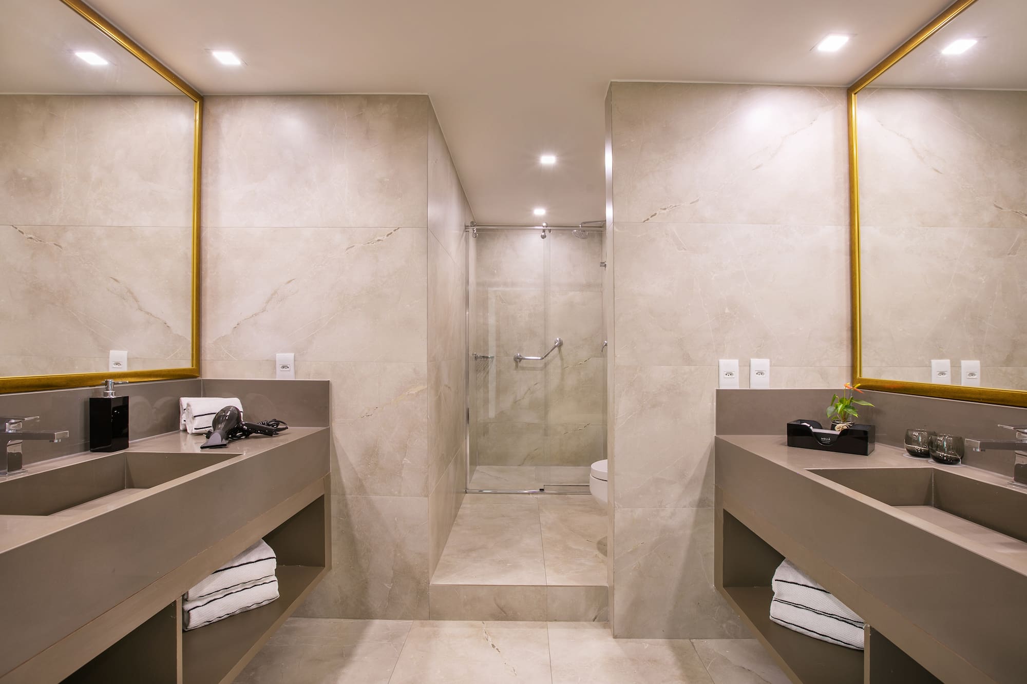 a bathroom with a shower and two sinks