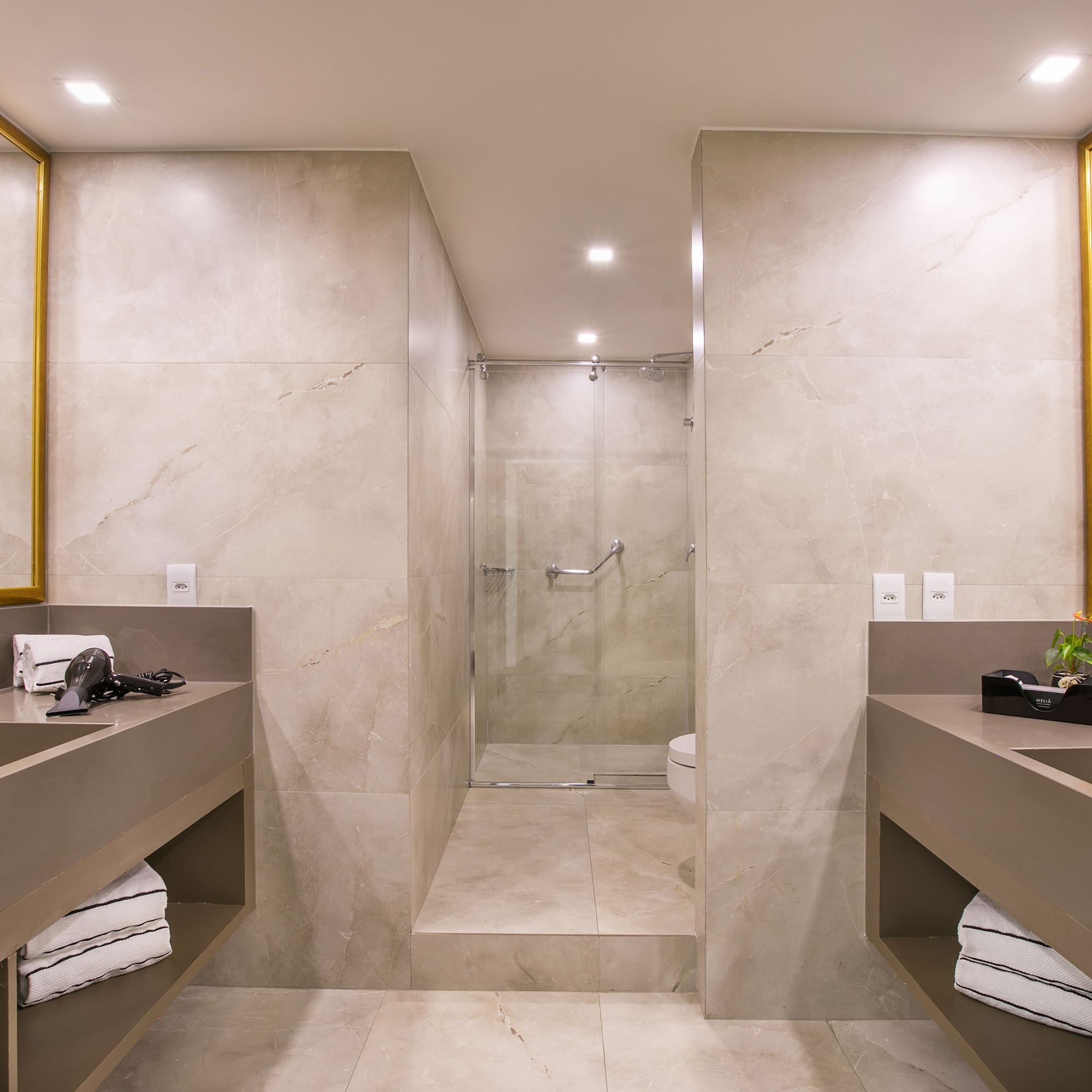 a bathroom with a shower and two sinks