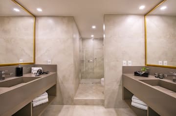 a bathroom with a shower and two sinks