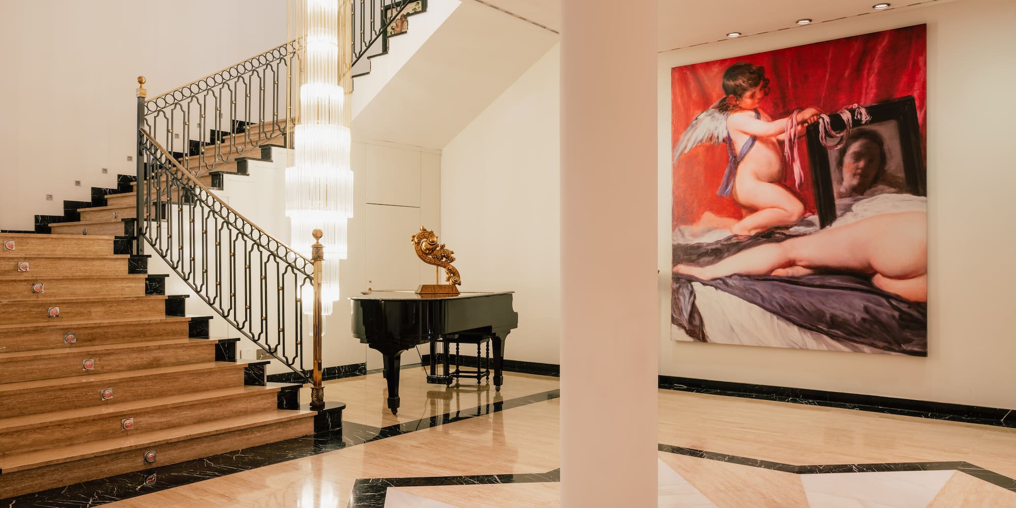 a staircase with a painting on the wall