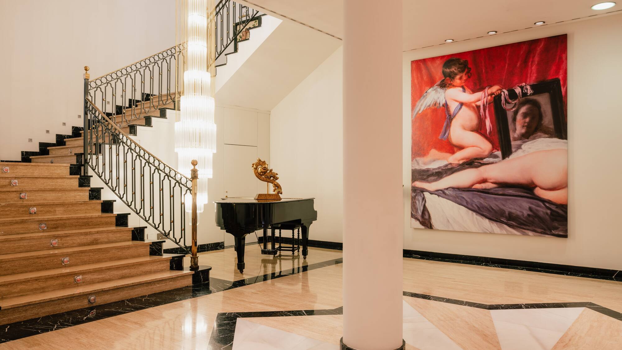 a staircase with a painting on the wall