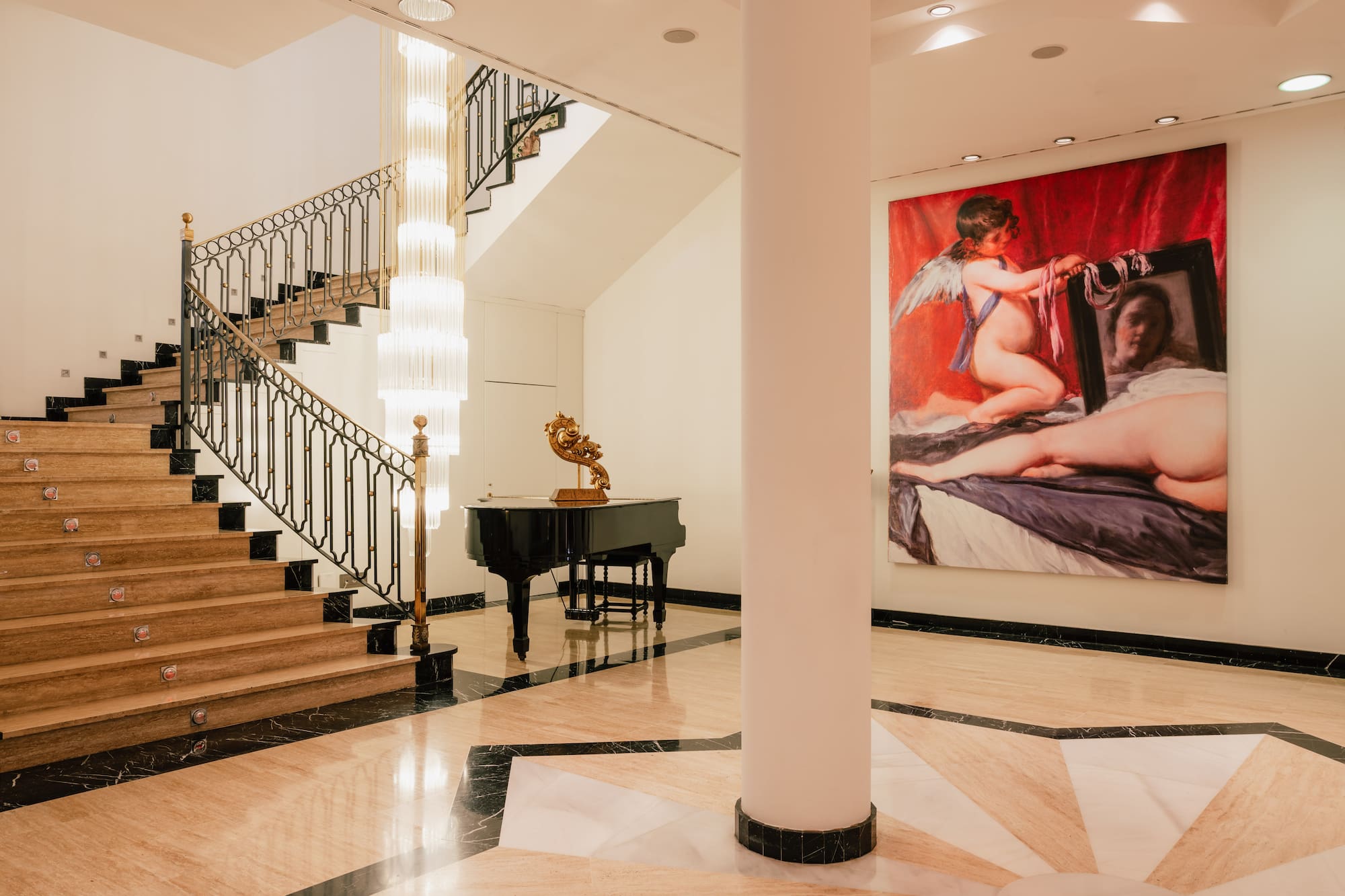 a staircase with a painting on the wall