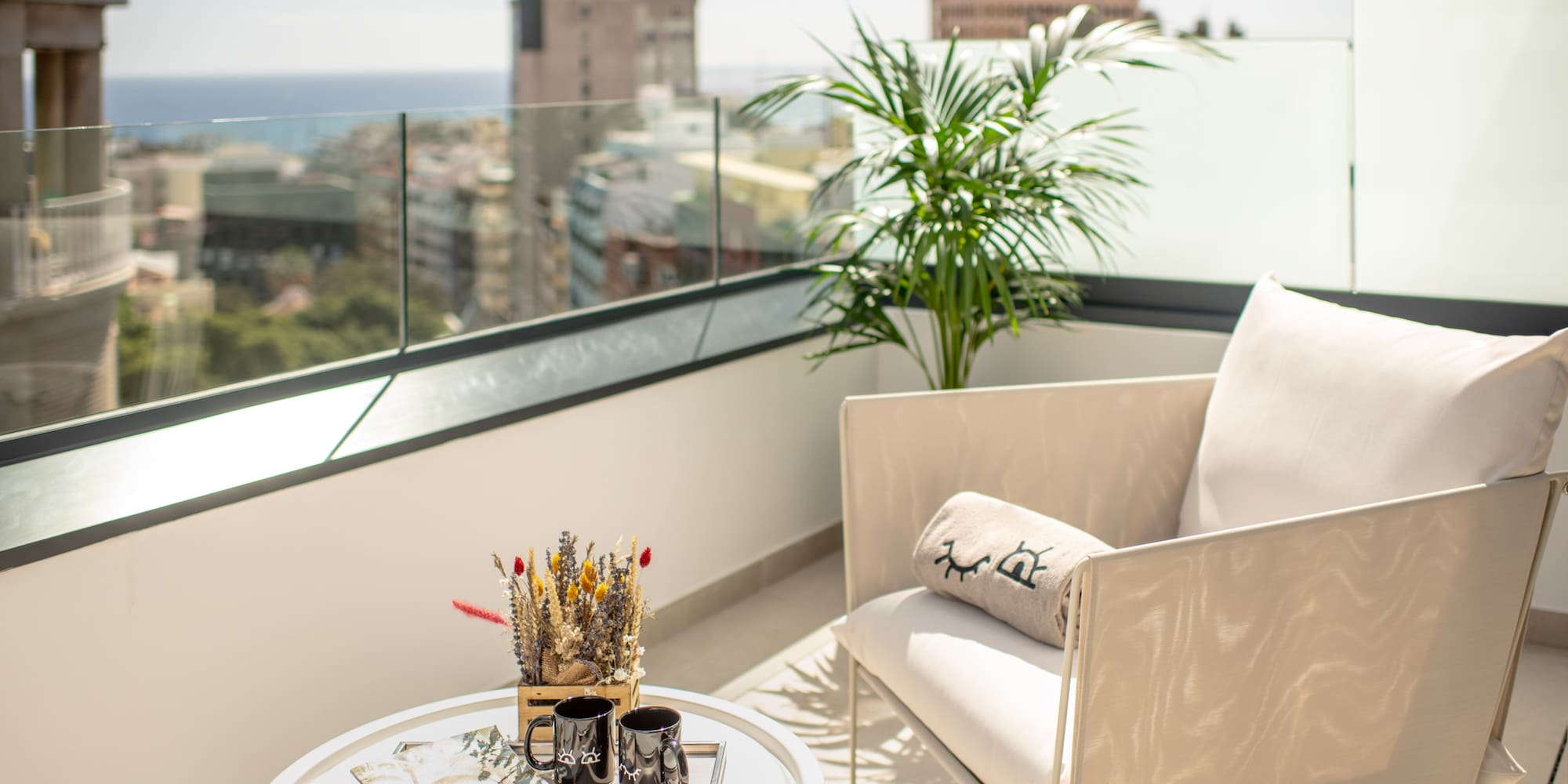 a white chair and a table on a balcony
