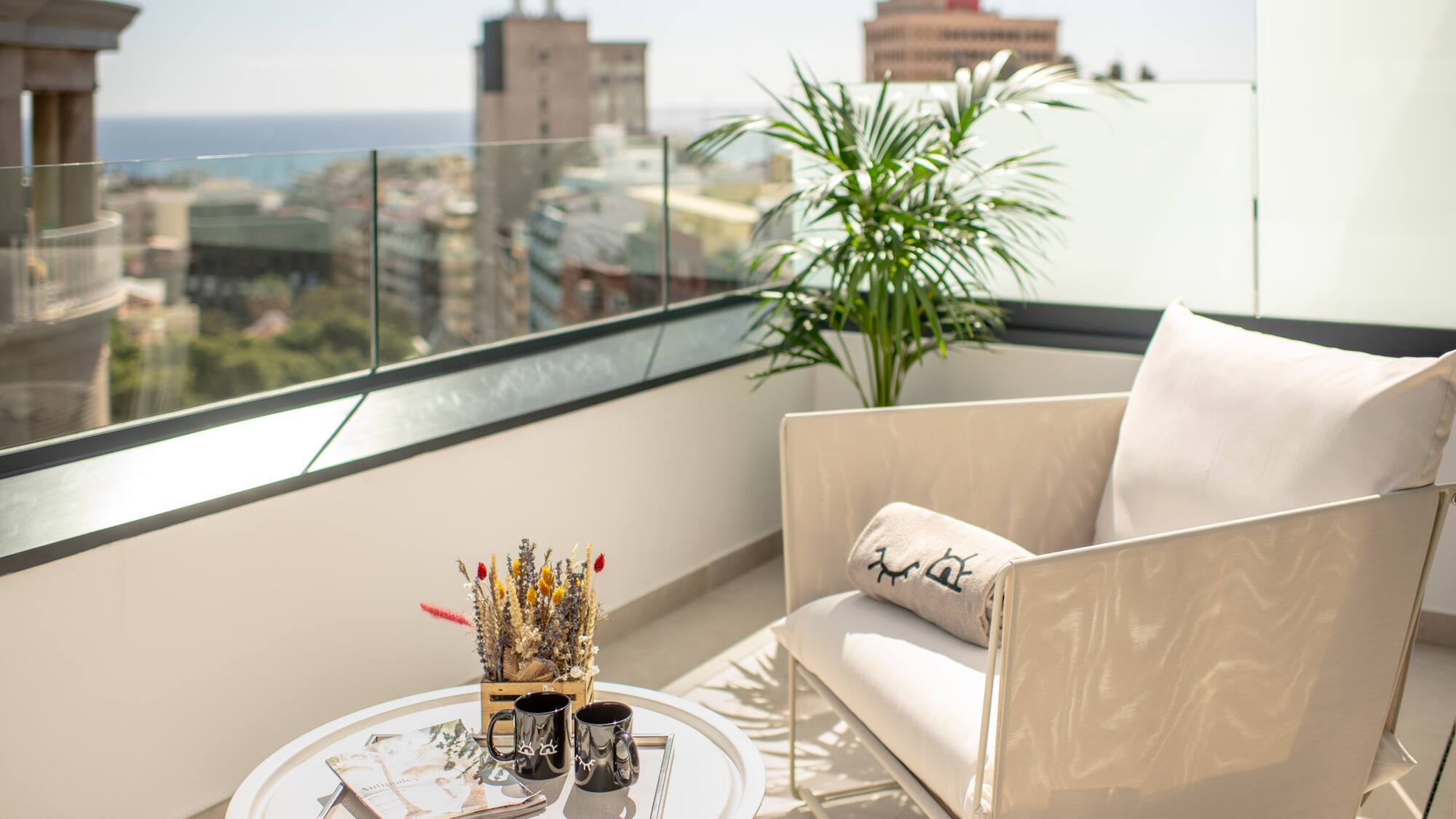 a white chair and a table on a balcony