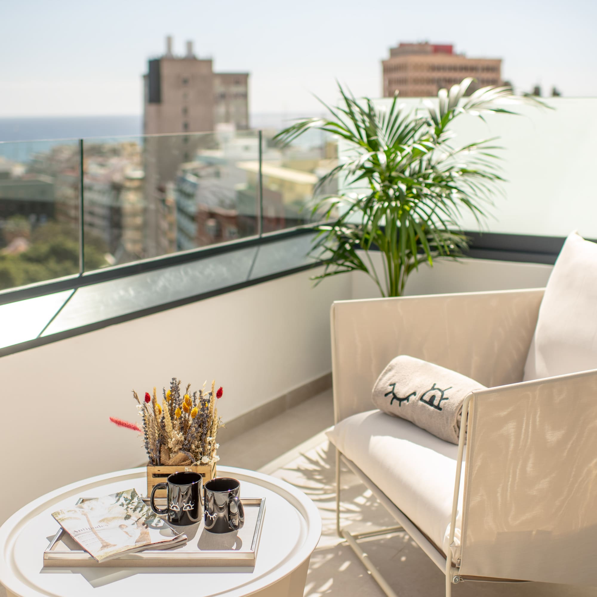 a white chair and a table on a balcony