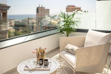 a white chair and a table on a balcony