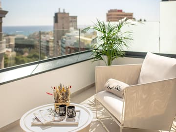 a white chair and a table on a balcony