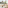 Sunny balcony with urban and sea views, outdoor armchair, coffee table, plant.