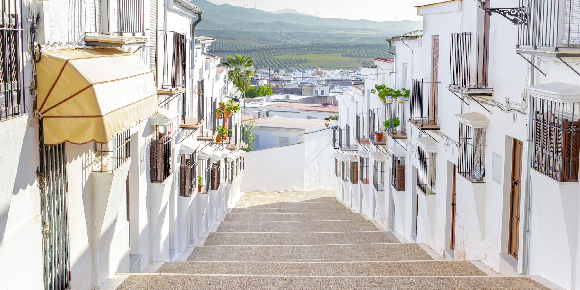 a white buildings with balconies and stairs