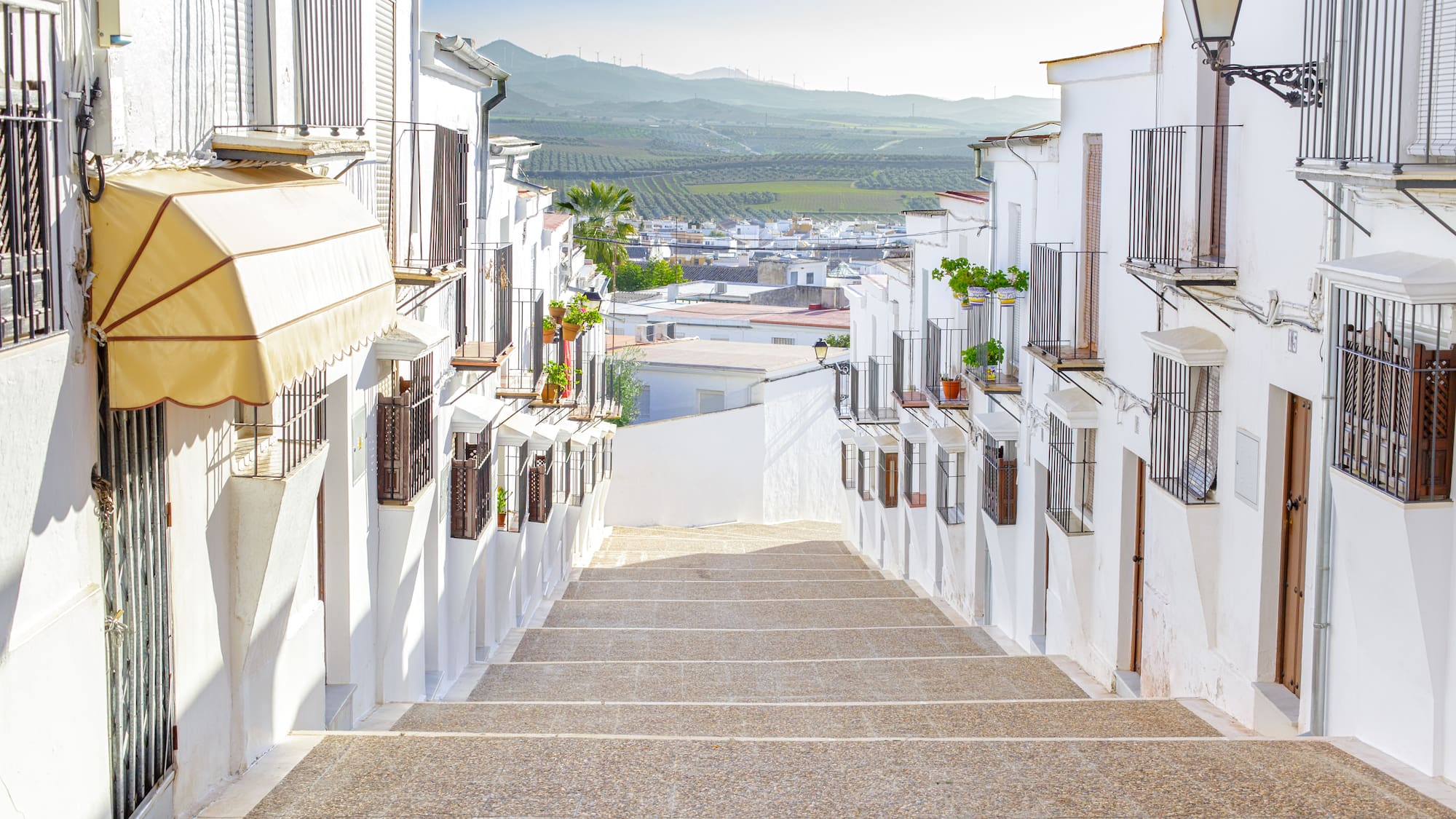 a white buildings with balconies and stairs