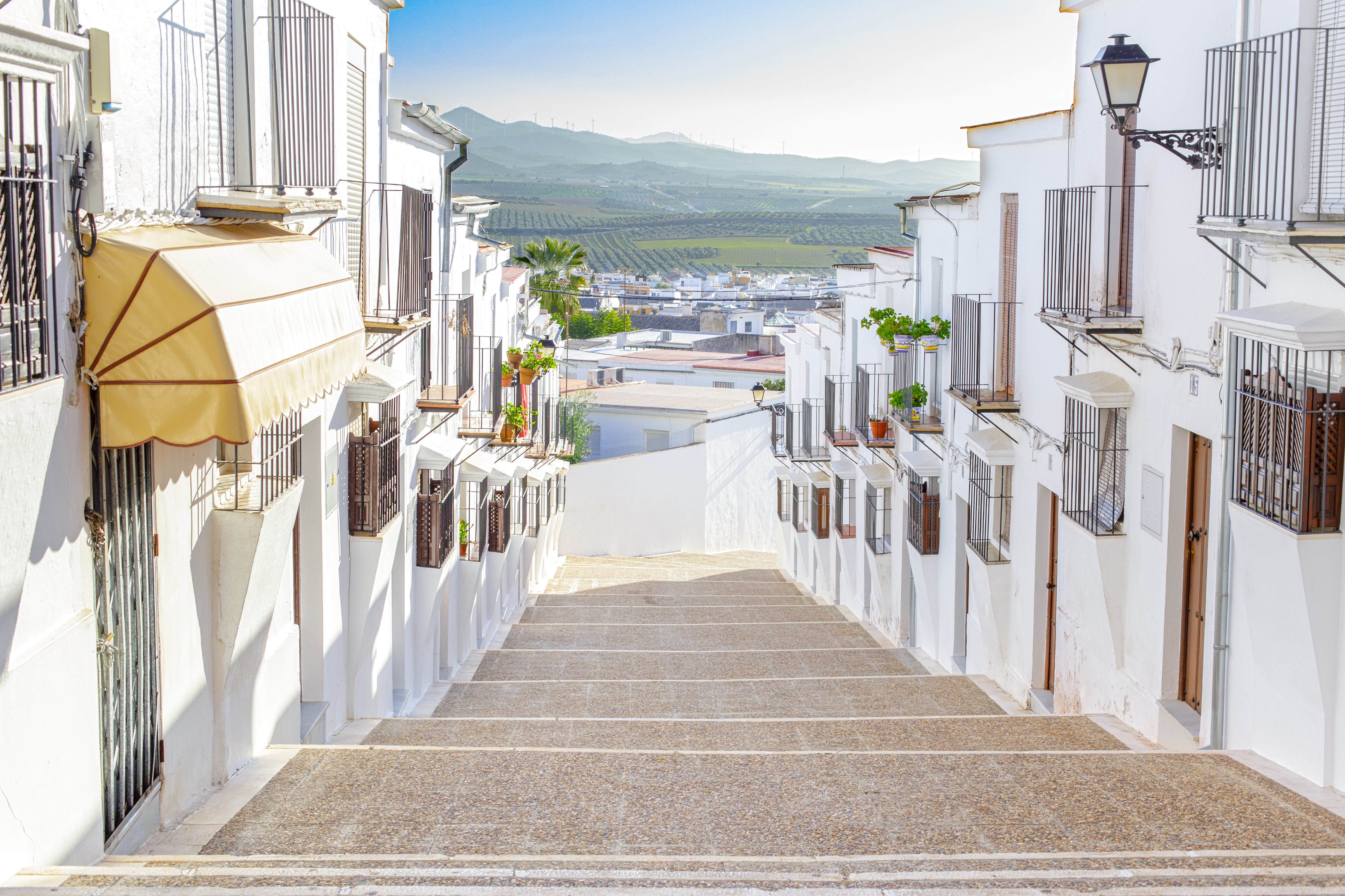 a white buildings with balconies and stairs
